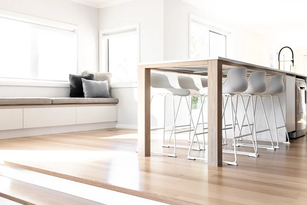 Bright and contemporary kitchen dining area with stylish seating designed by a leading interior designer in Hobart, showcasing minimalist elegance and functionality.