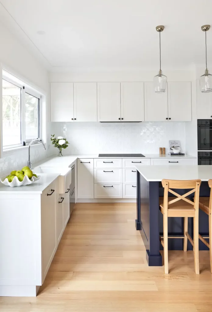 Spacious kitchen in Hobart featuring white cabinetry, modern fixtures, and elegant pendant lighting, designed by a skilled interior designer.